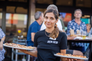 A person holding pizzas